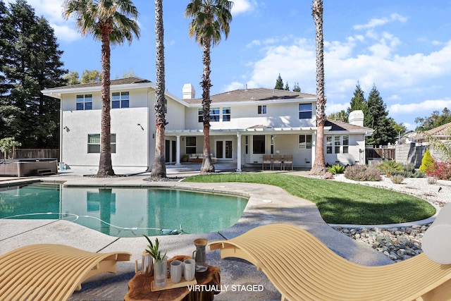 outdoor pool with a hot tub, a patio area, and central AC