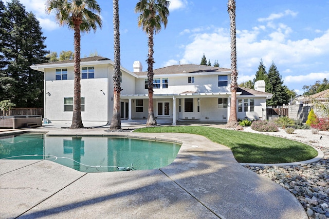 swimming pool with a hot tub, a patio area, fence, and central AC unit