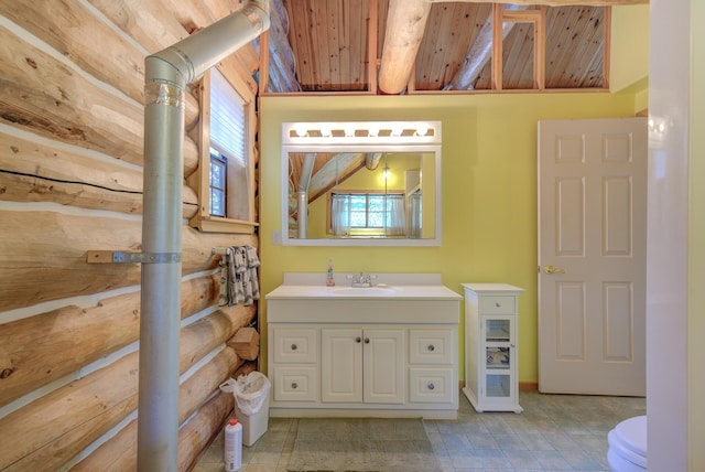 bathroom with toilet, vanity, and wood ceiling