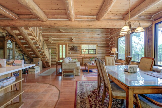 dining space with stairs, wood finished floors, beam ceiling, wood ceiling, and rustic walls
