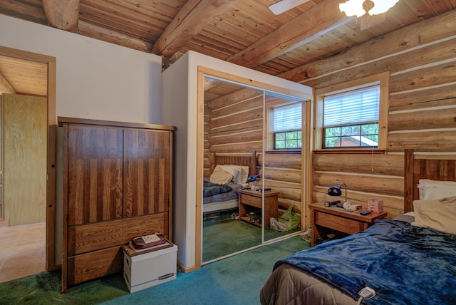 carpeted bedroom with beamed ceiling, rustic walls, and wooden ceiling