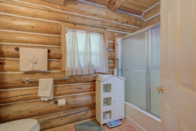 bathroom featuring toilet and combined bath / shower with glass door