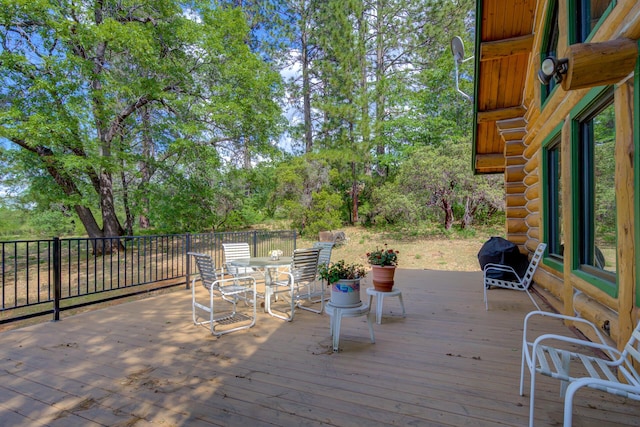 wooden deck featuring outdoor dining space