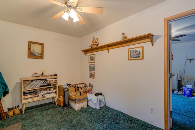 interior space with carpet flooring and ceiling fan