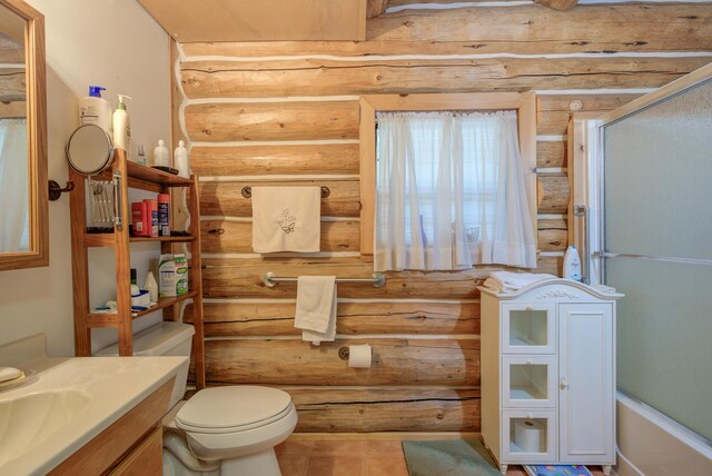 full bath with vanity, toilet, rustic walls, and tile patterned flooring
