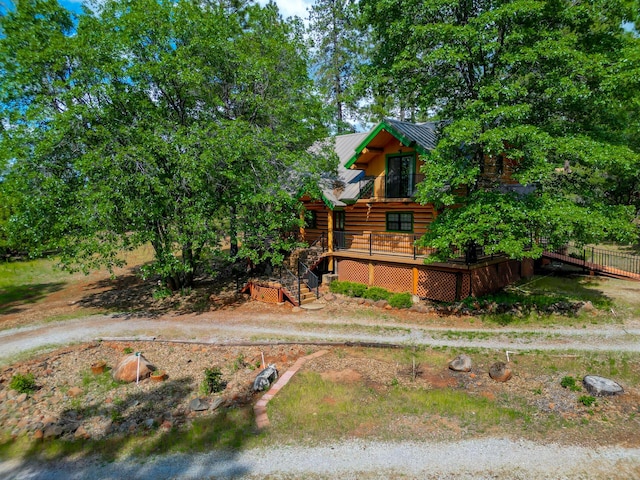 view of front of house with metal roof and stairs