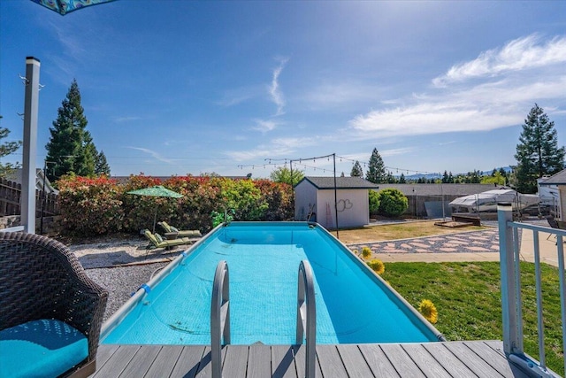 2919 Buckingham Dr, Shasta Lake, CA 96019 - outdoor pool featuring an outdoor structure, a lawn, a wooden deck, and a shed