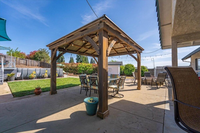 2919 Buckingham Dr, Shasta Lake, CA 96019 - view of patio with a fenced backyard, outdoor dining space, and a gazebo