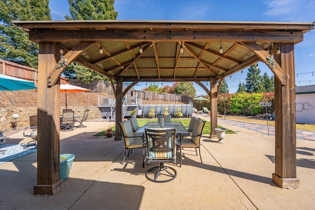 2919 Buckingham Dr, Shasta Lake, CA 96019 - view of patio featuring a gazebo, outdoor dining area, and fence