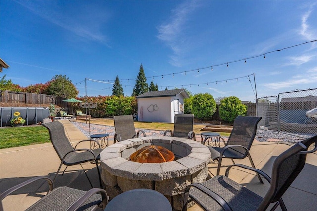 2919 Buckingham Dr, Shasta Lake, CA 96019 - view of patio / terrace with a fire pit, a fenced backyard, and an outdoor structure