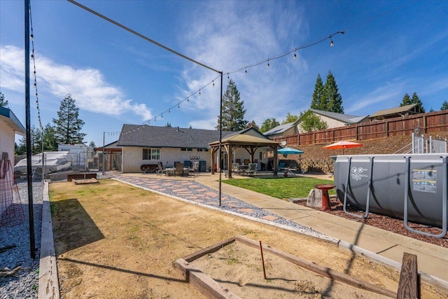 2919 Buckingham Dr, Shasta Lake, CA 96019 - view of yard featuring a patio area, a garden, a gazebo, and a fenced backyard