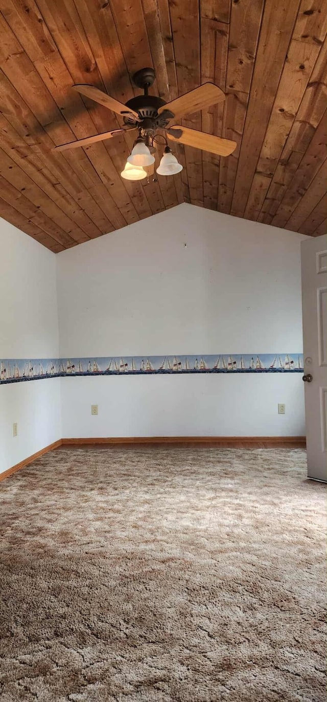 carpeted empty room featuring ceiling fan, baseboards, lofted ceiling, and wood ceiling