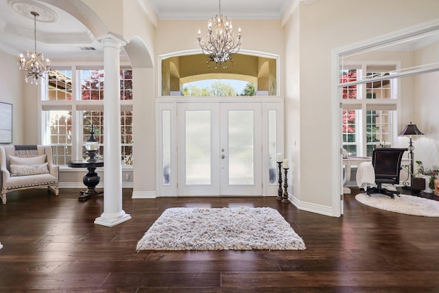13194 Tierra Heights Rd, Redding, CA 96003 - foyer entrance with decorative columns, ornamental molding, a high ceiling, wood-type flooring, and a notable chandelier