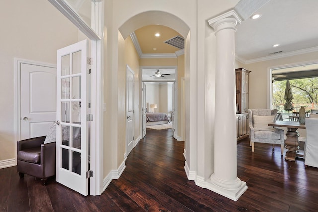 13194 Tierra Heights Rd, Redding, CA 96003 - hallway featuring visible vents, arched walkways, dark wood-style flooring, crown molding, and ornate columns