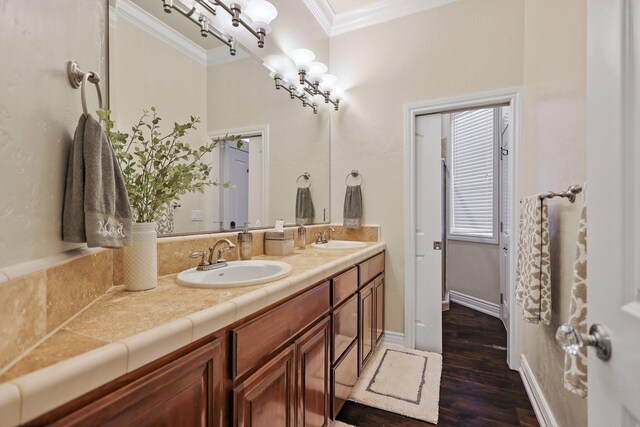 13194 Tierra Heights Rd, Redding, CA 96003 - bathroom with double vanity, a sink, ornamental molding, and wood finished floors
