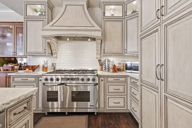 13194 Tierra Heights Rd, Redding, CA 96003 - kitchen with light stone countertops, double oven range, cream cabinets, custom range hood, and backsplash