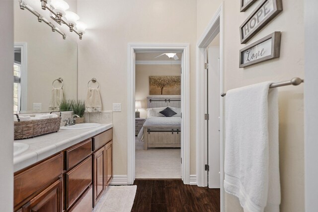 13194 Tierra Heights Rd, Redding, CA 96003 - ensuite bathroom with crown molding, connected bathroom, wood finished floors, a sink, and double vanity