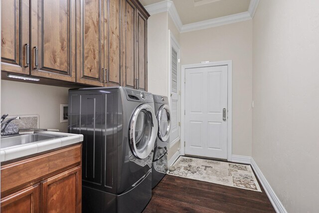 13194 Tierra Heights Rd, Redding, CA 96003 - laundry area with crown molding, a sink, dark wood-style floors, cabinet space, and washer and clothes dryer