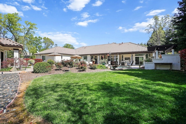 13194 Tierra Heights Rd, Redding, CA 96003 - back of property featuring a yard, a patio, stucco siding, and a tiled roof