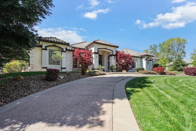 13194 Tierra Heights Rd, Redding, CA 96003 - mediterranean / spanish-style house with concrete driveway, stucco siding, a front lawn, a garage, and a tiled roof