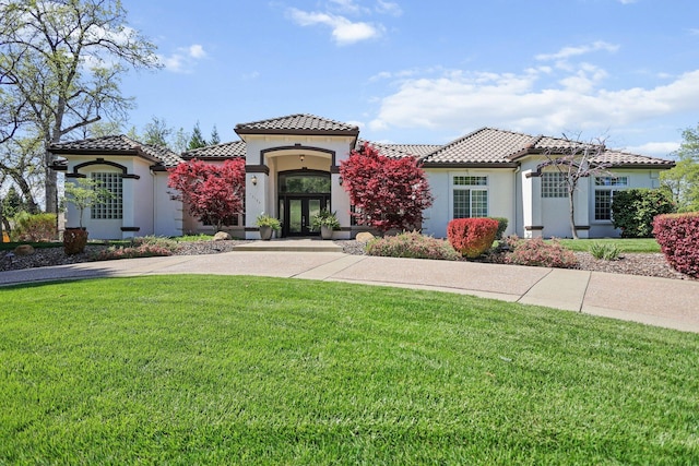 13194 Tierra Heights Rd, Redding, CA 96003 - mediterranean / spanish-style house with a tiled roof, french doors, stucco siding, and a front yard