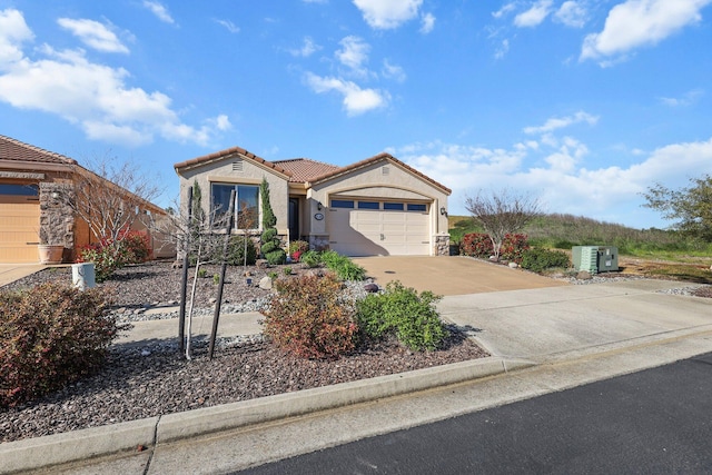 6180 Lucca Trl, Redding, CA 96003 - view of front of house with a tile roof, an attached garage, driveway, and stucco siding