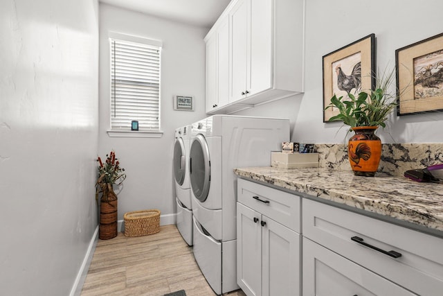 6180 Lucca Trl, Redding, CA 96003 - laundry area with washer and dryer, light wood-type flooring, baseboards, and cabinet space