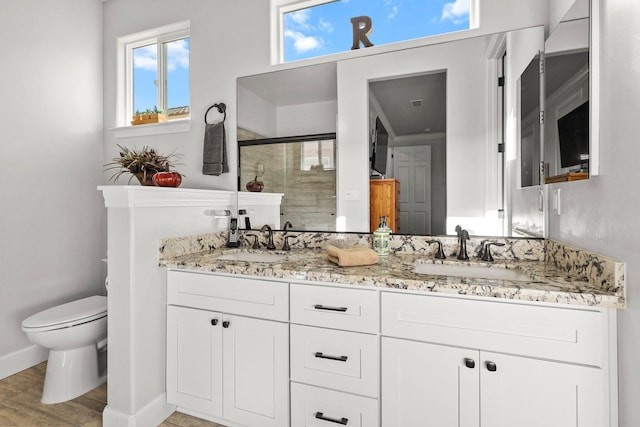 6180 Lucca Trl, Redding, CA 96003 - full bathroom featuring a shower stall, double vanity, a sink, and toilet