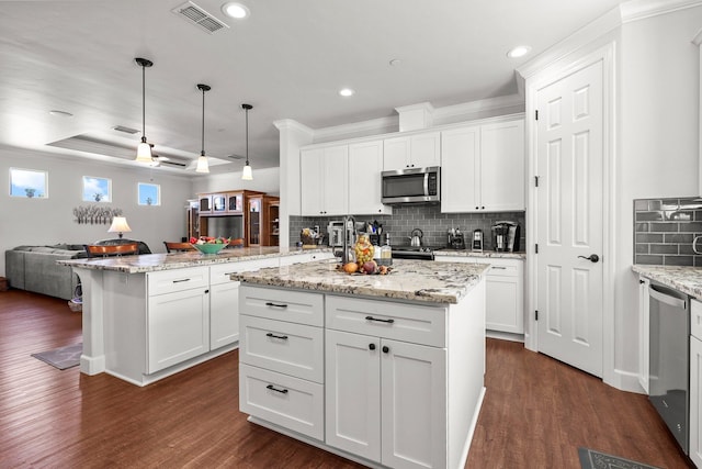 6180 Lucca Trl, Redding, CA 96003 - kitchen with open floor plan, a peninsula, visible vents, dark wood finished floors, and appliances with stainless steel finishes