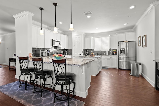 6180 Lucca Trl, Redding, CA 96003 - kitchen with crown molding, backsplash, appliances with stainless steel finishes, and a peninsula