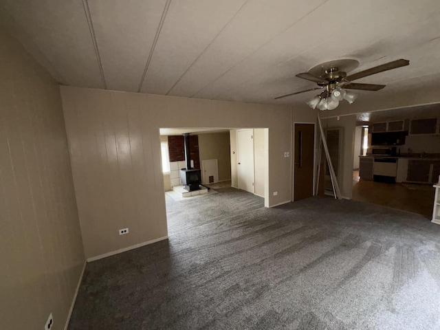 75 Pine Dr, Lookout, CA 56054 - carpeted empty room featuring a wood stove and ceiling fan
