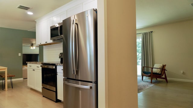 5080 Debbie Ln, Redding, CA 96002 - kitchen with appliances with stainless steel finishes, light wood-type flooring, white cabinetry, baseboards, and recessed lighting
