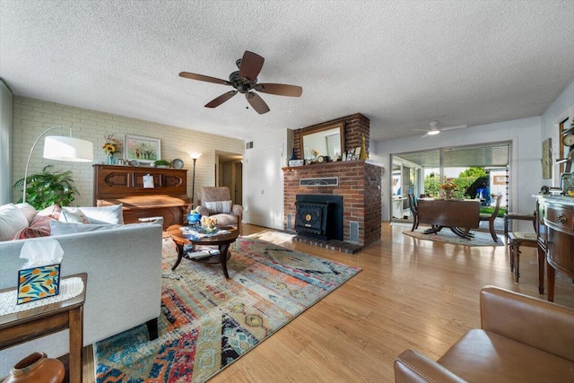 105 Kaer Ave, Red Bluff, CA 96080 - living area with a textured ceiling, wood finished floors, ceiling fan, and brick wall