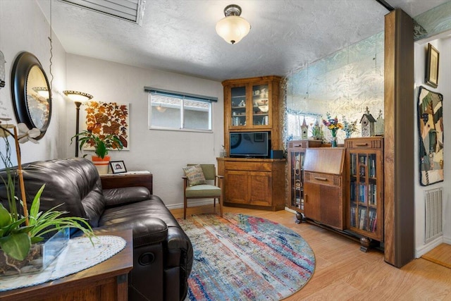 105 Kaer Ave, Red Bluff, CA 96080 - living area with visible vents, baseboards, light wood-type flooring, and a textured ceiling