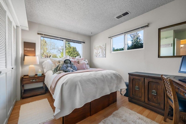 105 Kaer Ave, Red Bluff, CA 96080 - bedroom featuring visible vents, a textured ceiling, and light wood-style flooring