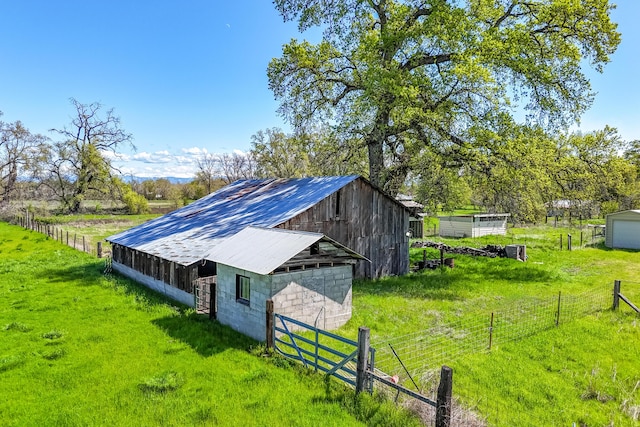 5995 Bellevue Ln, Anderson, CA 96007 - view of barn with fence, a lawn, and a rural view
