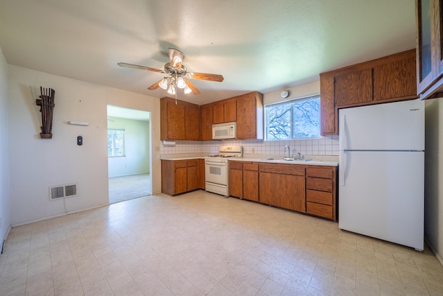 5995 Bellevue Ln, Anderson, CA 96007 - kitchen featuring white appliances, light countertops, visible vents, light floors, and a sink