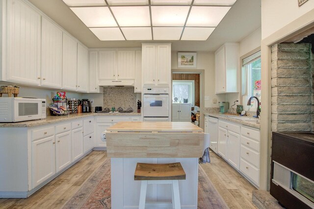 45517 Pittville Rd, Mcarthur, CA 96056 - kitchen featuring a sink, white appliances, under cabinet range hood, light wood finished floors, and a kitchen island