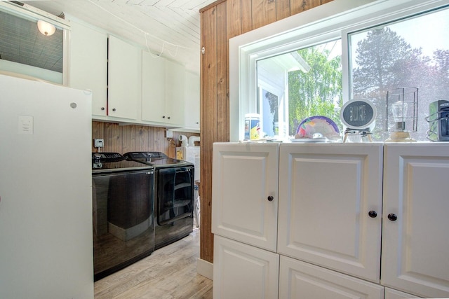 45517 Pittville Rd, Mcarthur, CA 96056 - laundry area with light wood-style flooring, washing machine and clothes dryer, and cabinet space