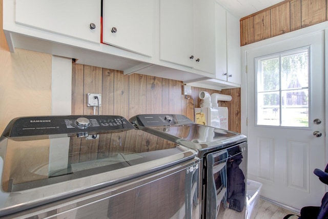 45517 Pittville Rd, Mcarthur, CA 96056 - laundry area featuring cabinet space, wood walls, independent washer and dryer, and light wood-style floors