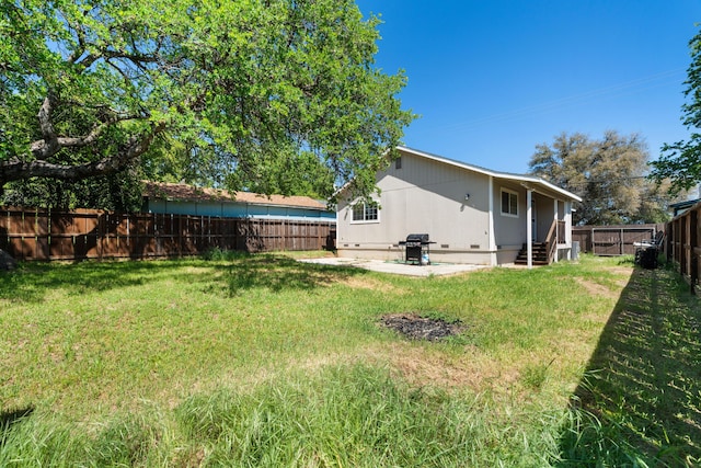 view of yard featuring a patio and a fenced backyard