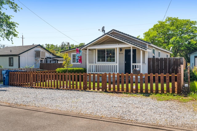 bungalow with board and batten siding and a fenced front yard