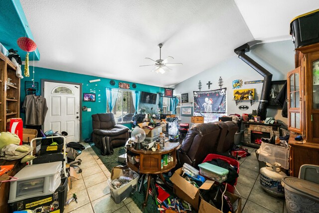 tiled living room featuring a ceiling fan and lofted ceiling