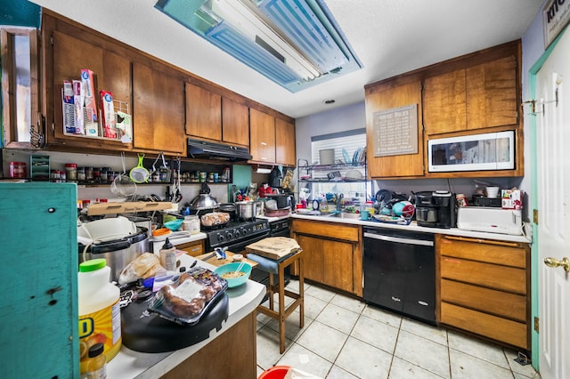 kitchen with brown cabinetry, light countertops, and black appliances