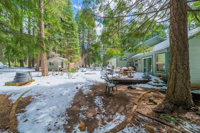 yard covered in snow featuring an outdoor structure
