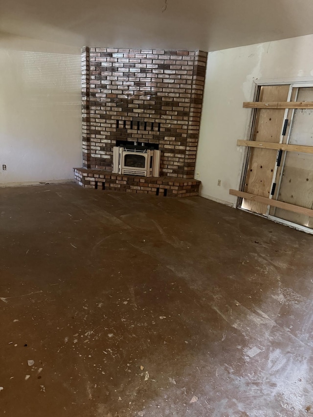 unfurnished living room with heating unit and concrete flooring