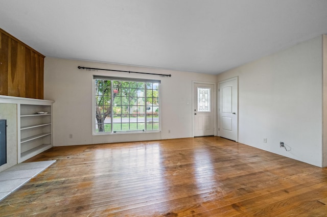 3082 Lawrence Rd, Redding, CA 96002 - unfurnished living room featuring wood-type flooring and a tile fireplace