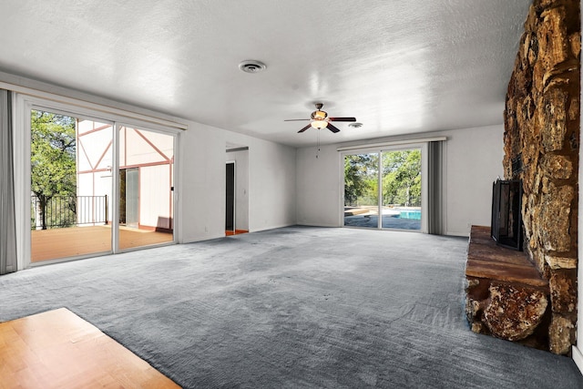 16588 Stanislaus Dr, Redding, CA 96001 - carpeted living area featuring visible vents, ceiling fan, baseboards, and a textured ceiling