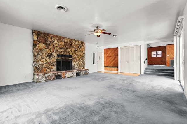 16588 Stanislaus Dr, Redding, CA 96001 - unfurnished living room with visible vents, a ceiling fan, a fireplace, stairway, and carpet flooring