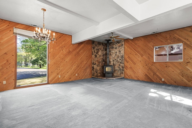 16588 Stanislaus Dr, Redding, CA 96001 - unfurnished living room with a wood stove, carpet flooring, visible vents, and beam ceiling